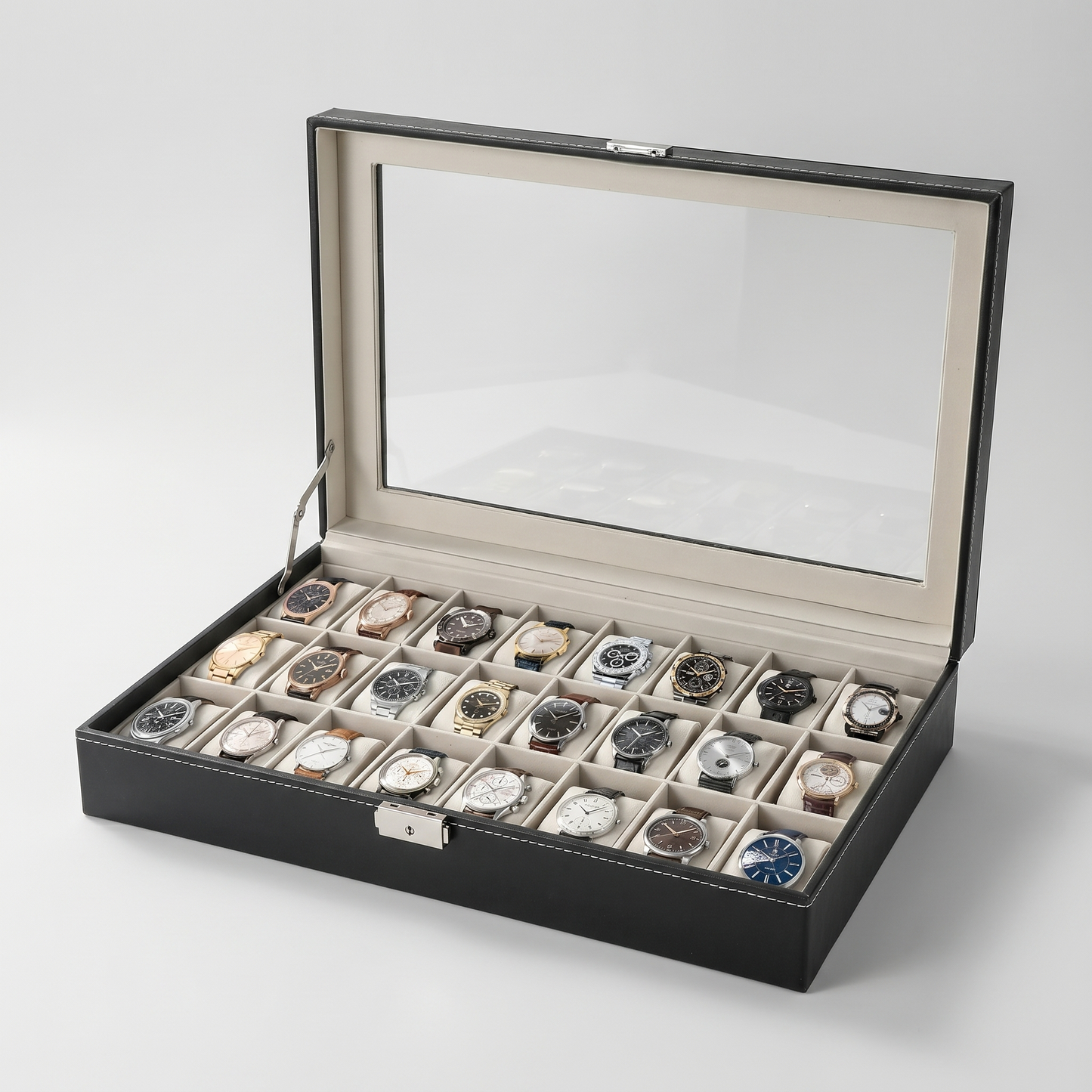 The Collector 24-slot watch box open with glass top, black leather-grain, cream velvet